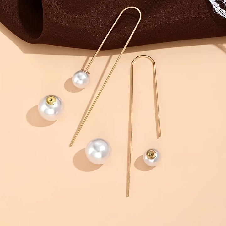 Statement oorbellen met stralende parel